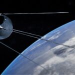 Satellite orbiting earth with clouds below