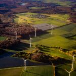 Wind turbines and solar panels in a rural landscape.