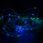 a bunch of blue and green lights in the dark