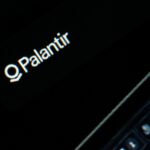 Palantir logo on a dark screen.