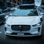 White self-driving car on a city street