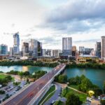 An aerial view of the Austin skyline and Congress Avenue Bridge over Lady Bird Lake