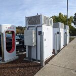 An electric car charging at a Tesla Supercharger station in San Mateo, California