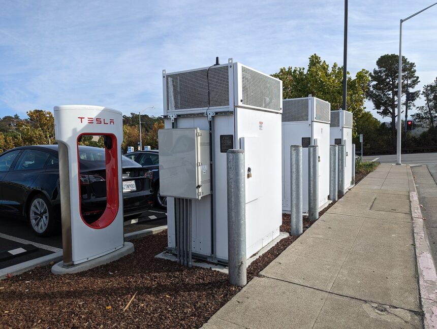 An electric car charging at a Tesla Supercharger station in San Mateo, California