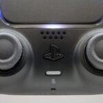 Close-up of the joysticks on a black PlayStation 5 DualSense controller