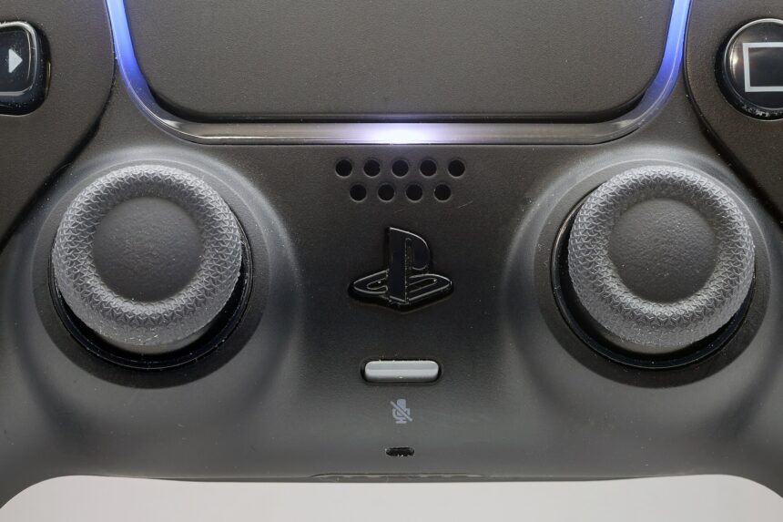 Close-up of the joysticks on a black PlayStation 5 DualSense controller