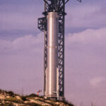 A SpaceX Super Heavy booster on the launch tower at Starbase, Texas