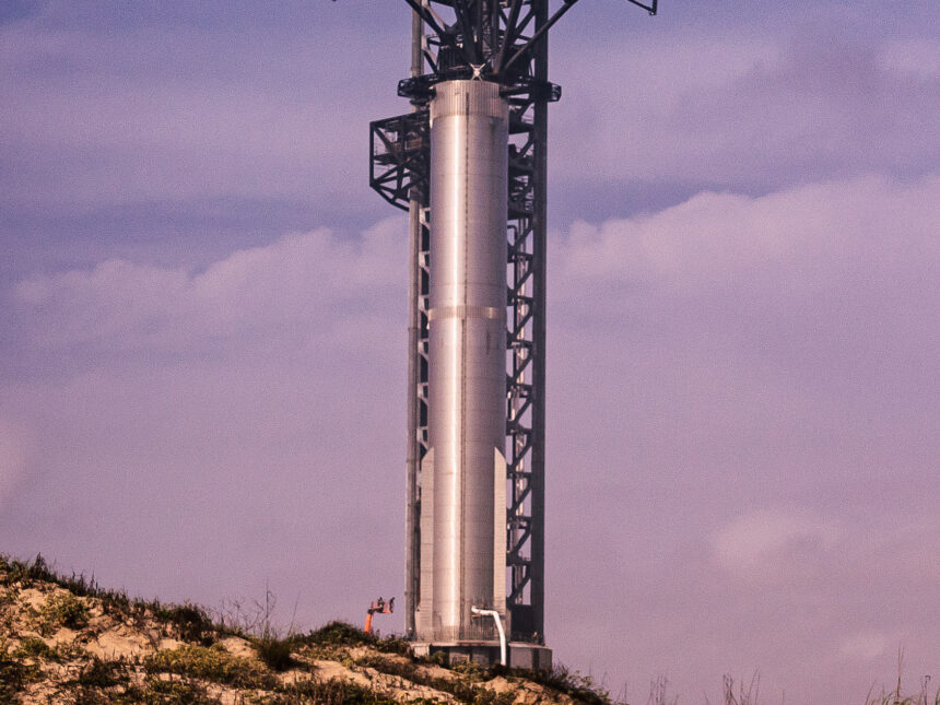 A SpaceX Super Heavy booster on the launch tower at Starbase, Texas