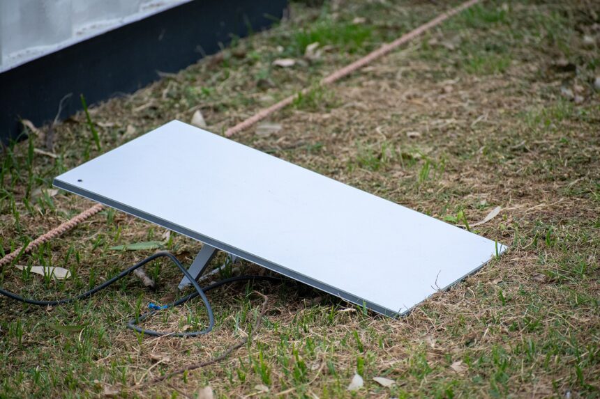 A Starlink satellite internet dish set up on the grass
