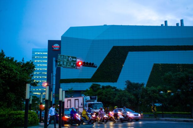 TSMC fab buildings in Hsinchu, Taiwan, at dusk with traffic in the foreground